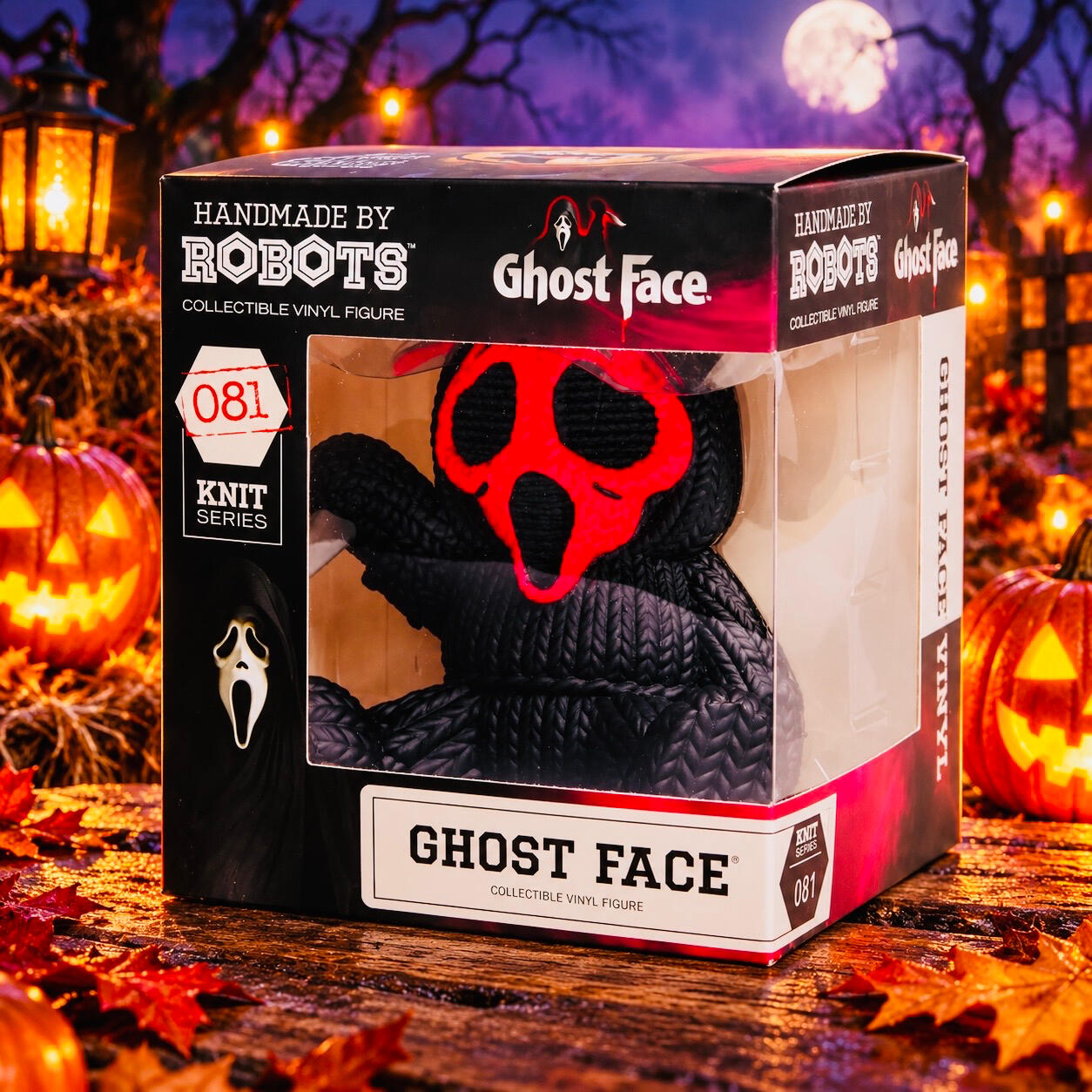 Boxed Ghost Face figure with a Pink mask and black robe, displayed among glowing jack-o’-lanterns and lanterns.