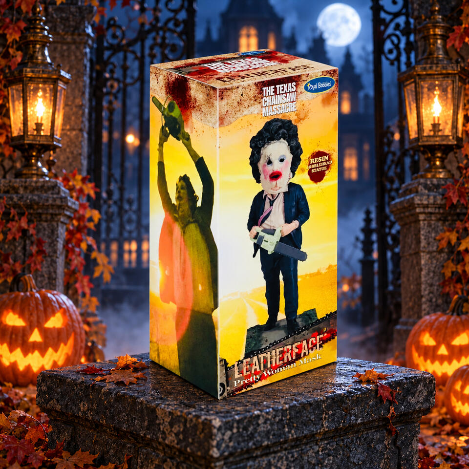 Boxed Leatherface bobblehead with artwork showing his Pretty Woman mask and chainsaw, displayed among pumpkins and lanterns.