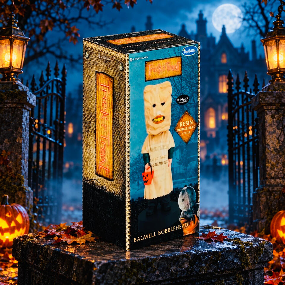 Boxed Bagwell bobblehead featuring a paper-bag mask and orange pumpkin bucket, displayed outside moonlit manor gates with glowing pumpkins.