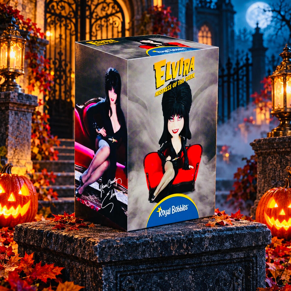 Elvira, Mistress of the Dark — Royal Bobbles Boxed Elvira bobblehead with artwork of her seated on a red couch, displayed among pumpkins and lanterns outside a haunted manor.